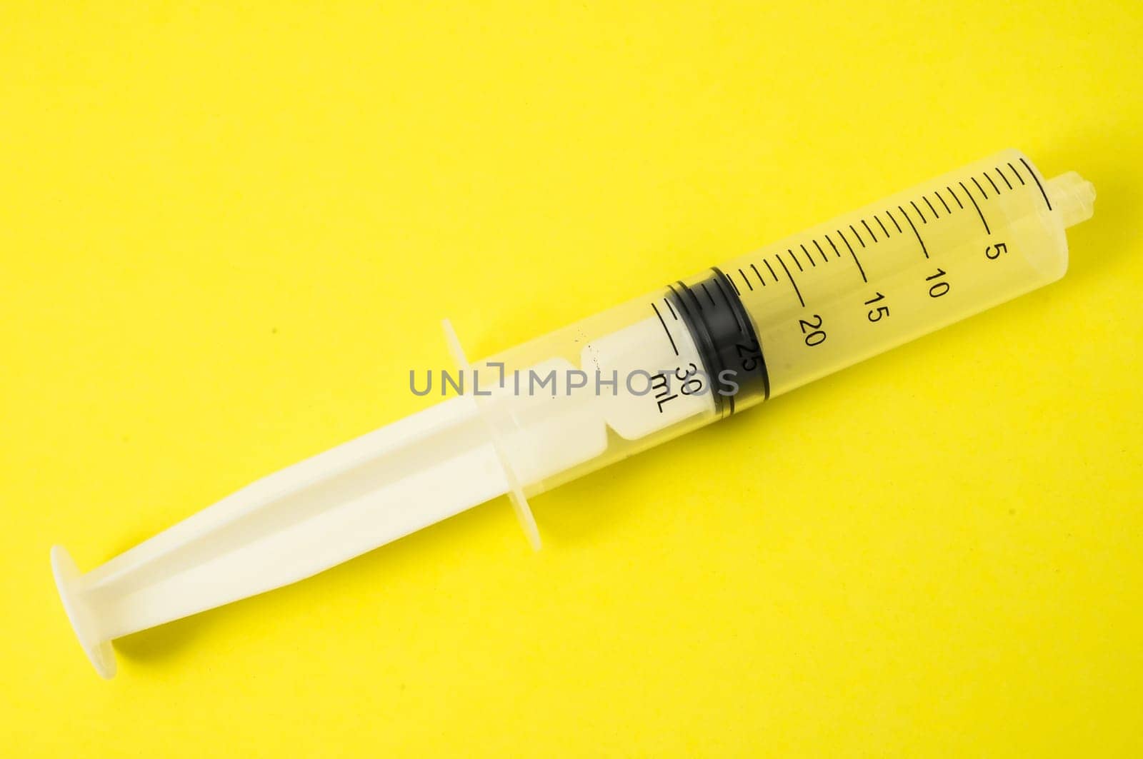 Big Black and White Syringe on a Colored Background