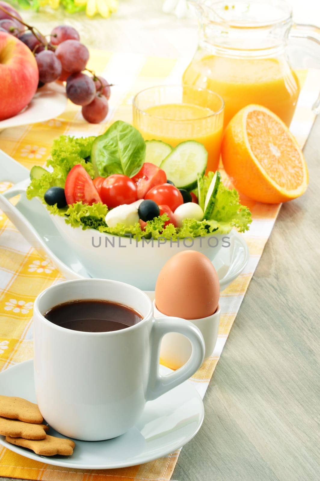 Breakfast with coffee, orange juice, croissant, egg, vegetables and fruits