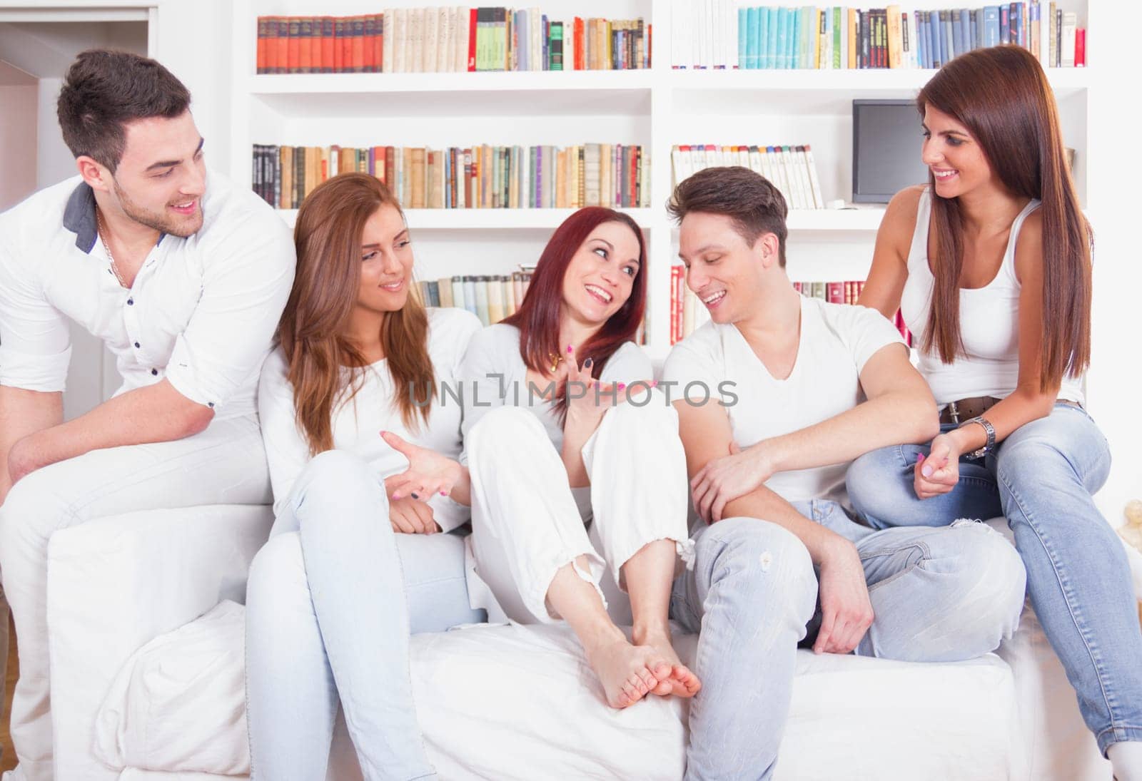 Group of pretty young people smiling on the couch