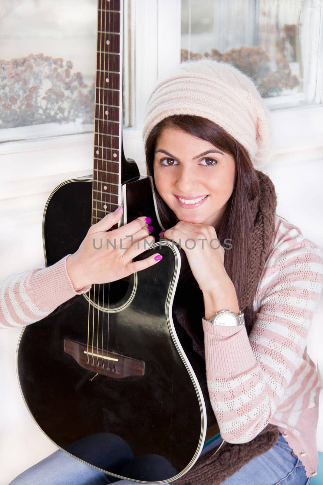 pretty girl holding the guitar and smiling
