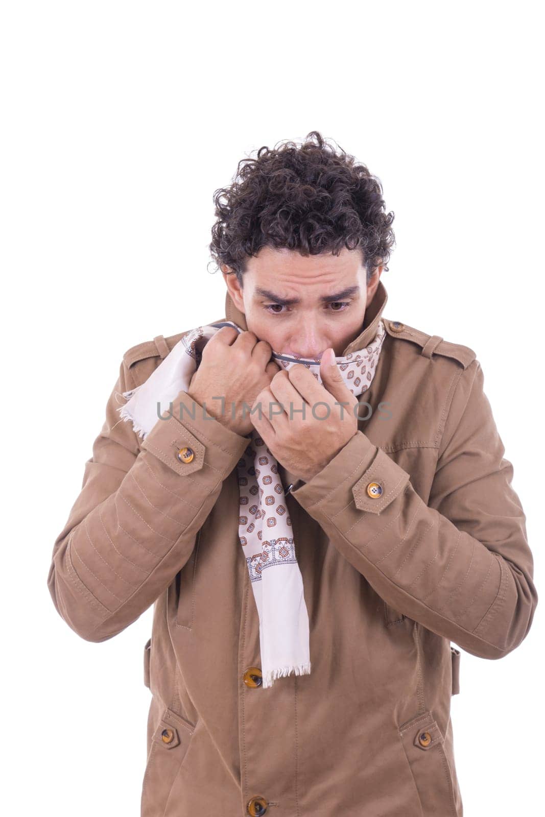 adult man in the coat covers the face with scarf against the coldness