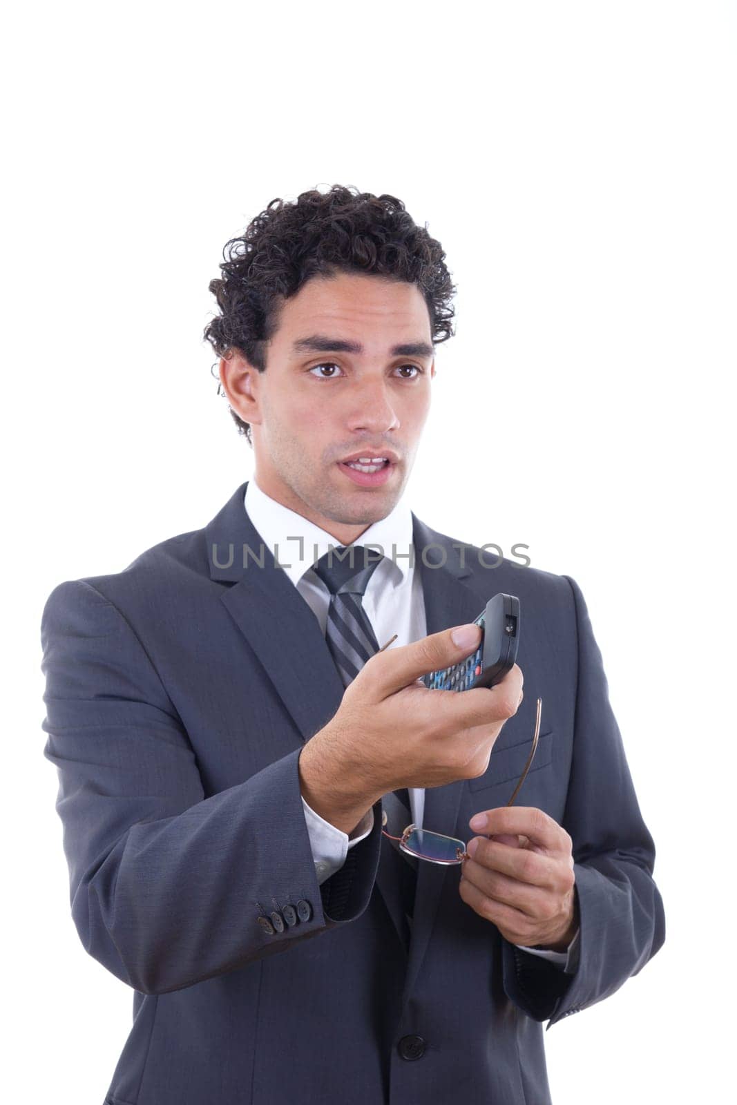 Man in suit holding glasess and changing channel with remote