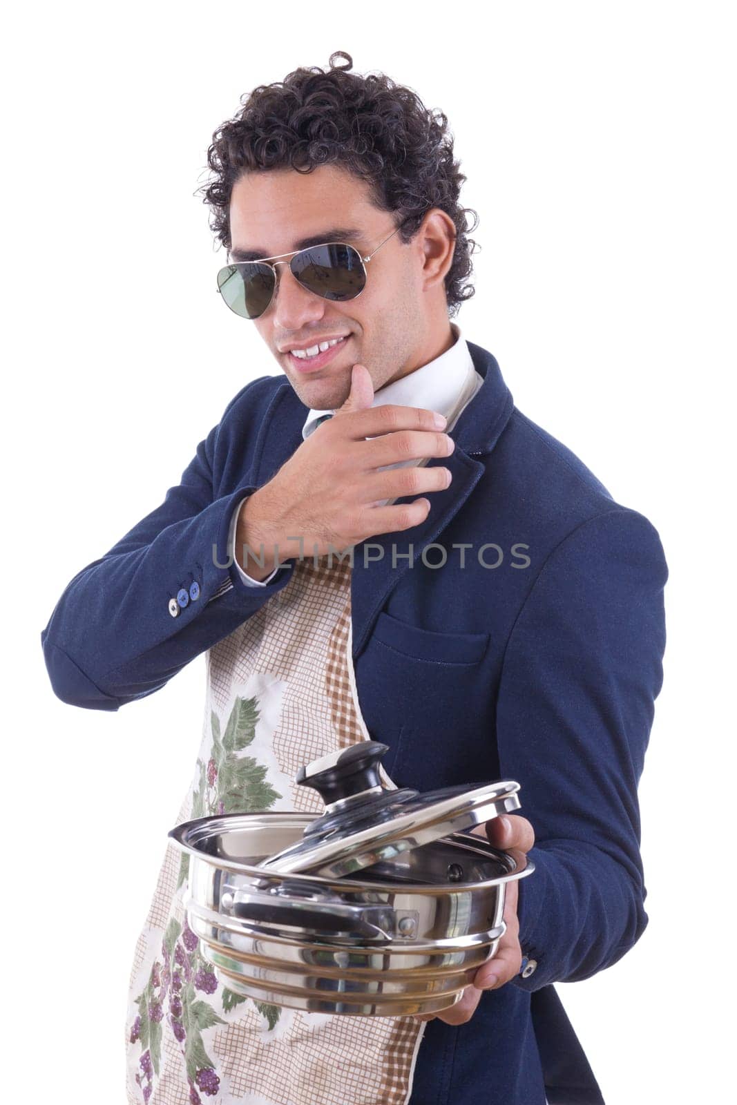 handsome man in suit with an apron holding a cooking pot