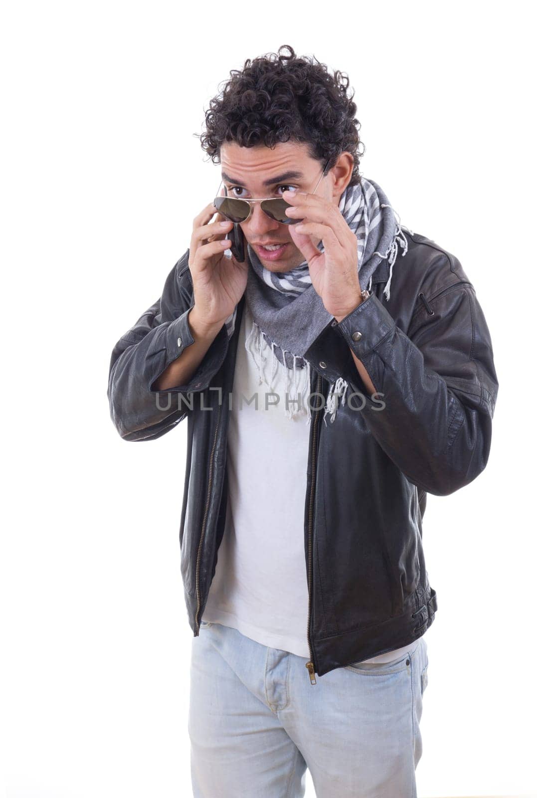 good looking adult man in a leather jacket talking over phone