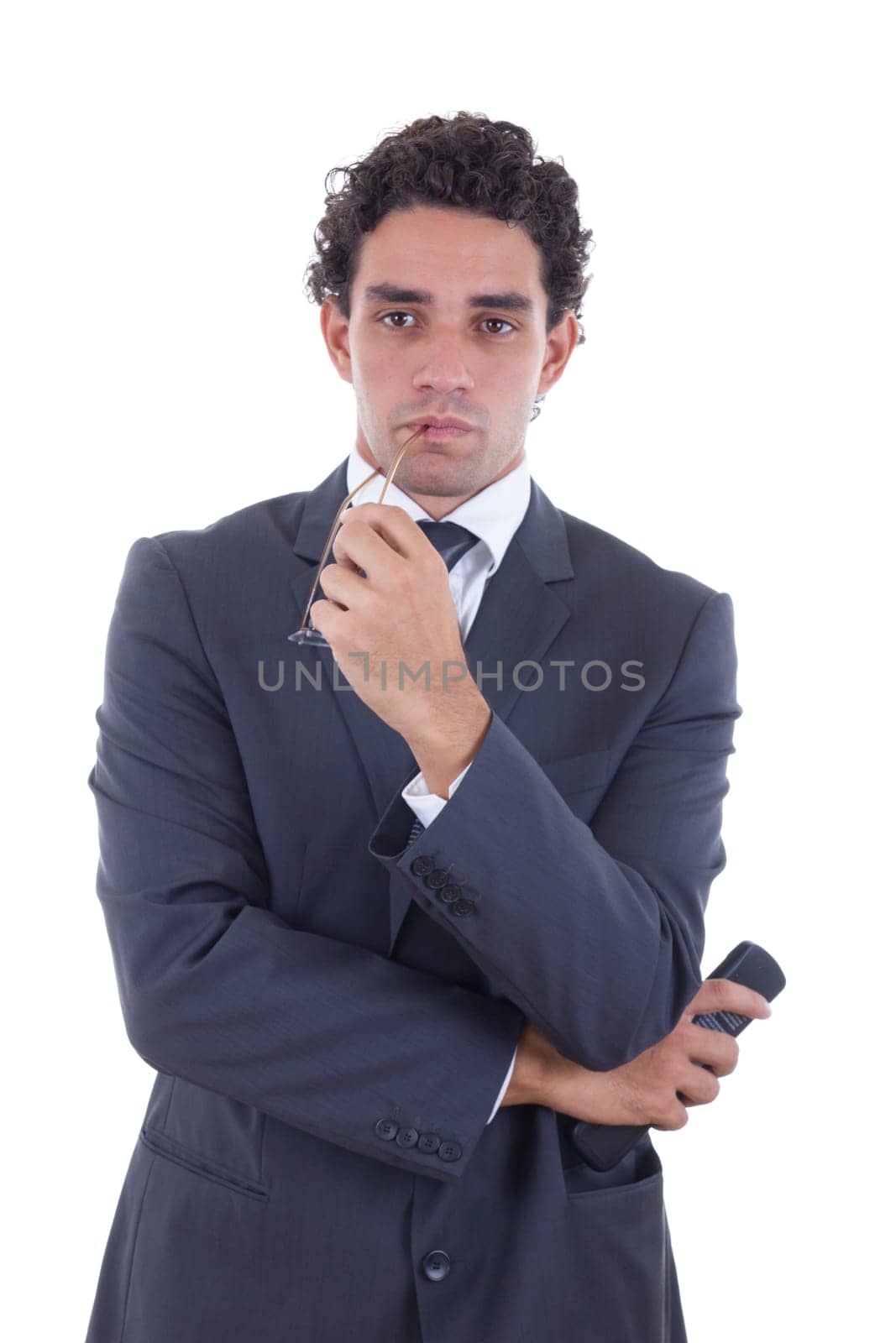 adult man in suit holding the remote while watching TV