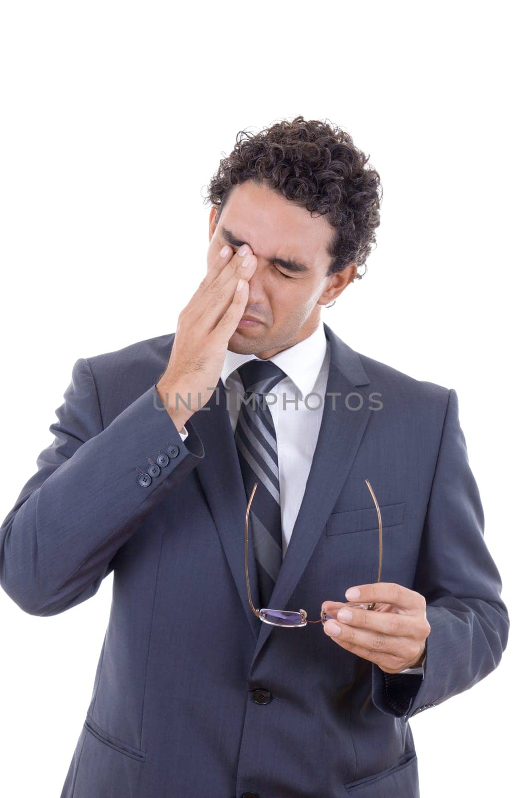 man with a hard headache holding glasses