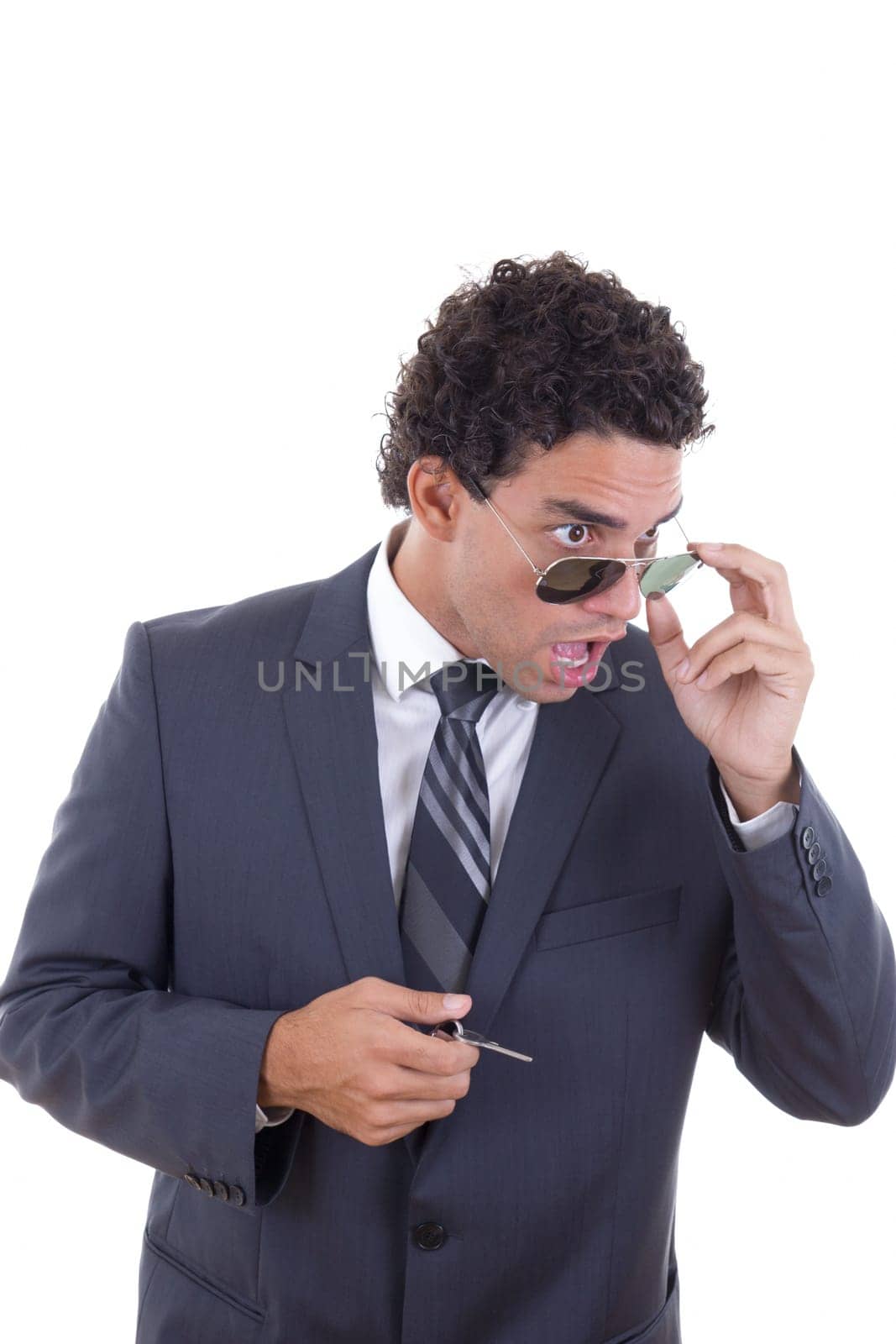 surprised and shocked young businessman with glasses holding keys