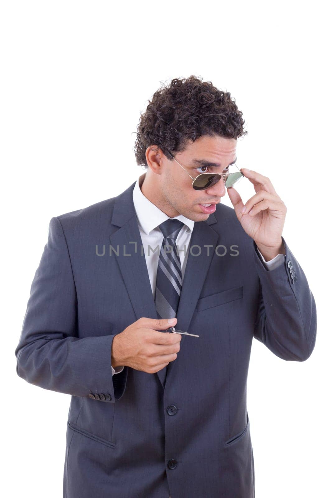 surprised young businessman with glasses holding keys