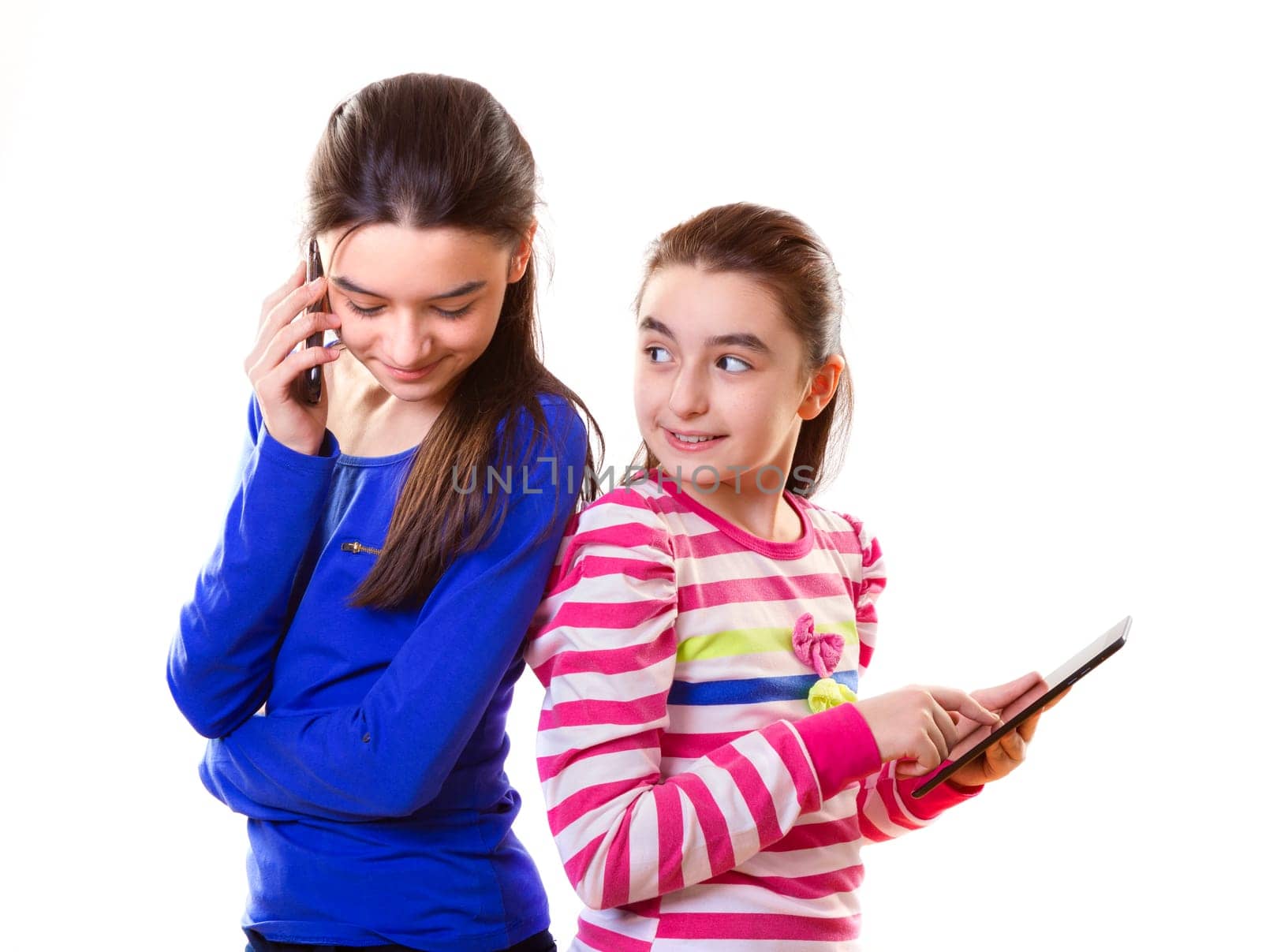 Happy teen girls with digital tablet and smartphone on white background