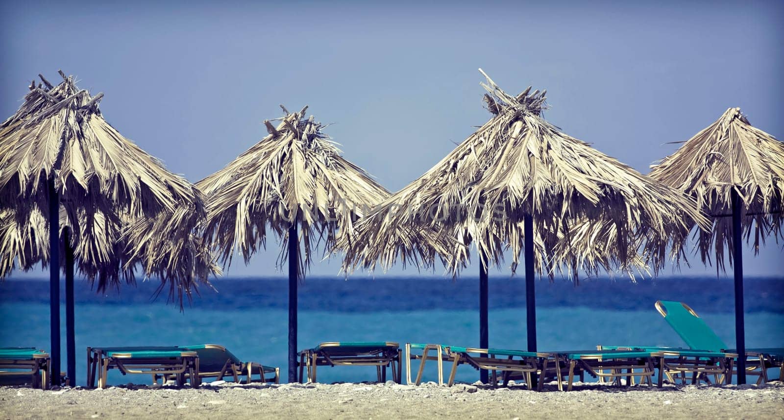 Vintage photo of chairs and umbrellas on the beach