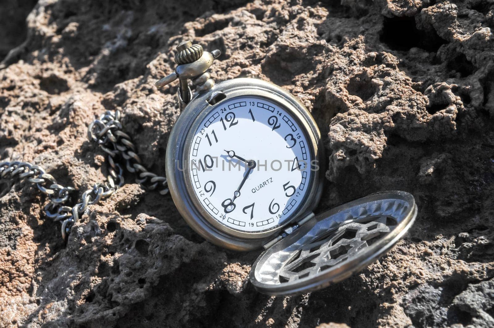 Time Concept Classic Vintage Pocket Clock on the Volcanic Rocks