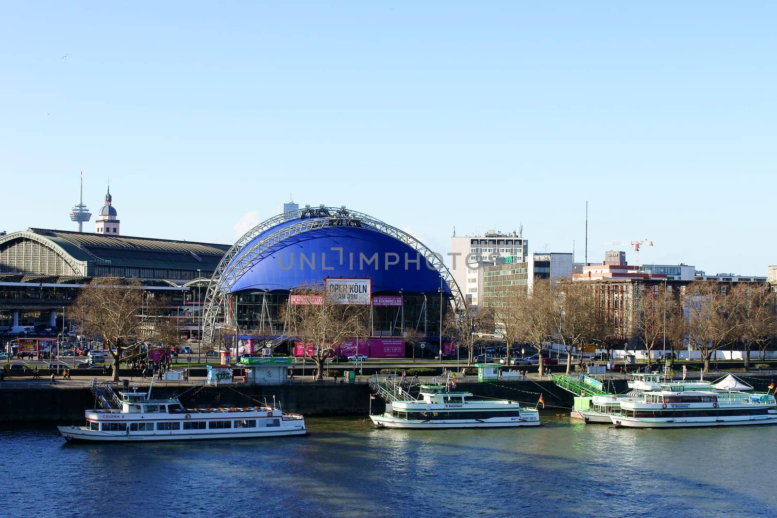 Cologne,Germany – February 02,2014: The Cologne Opera at the Cathedral opposite a jetty with passenger ships on February 2,2014 in Cologne.