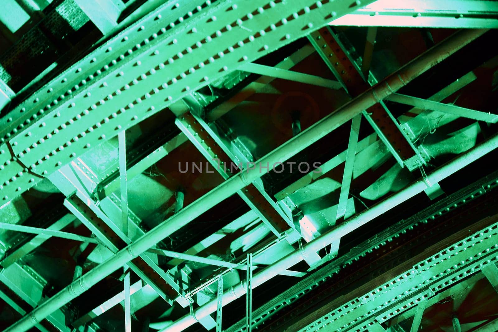 The photograph of a tunnel ceiling illuminated with green light.