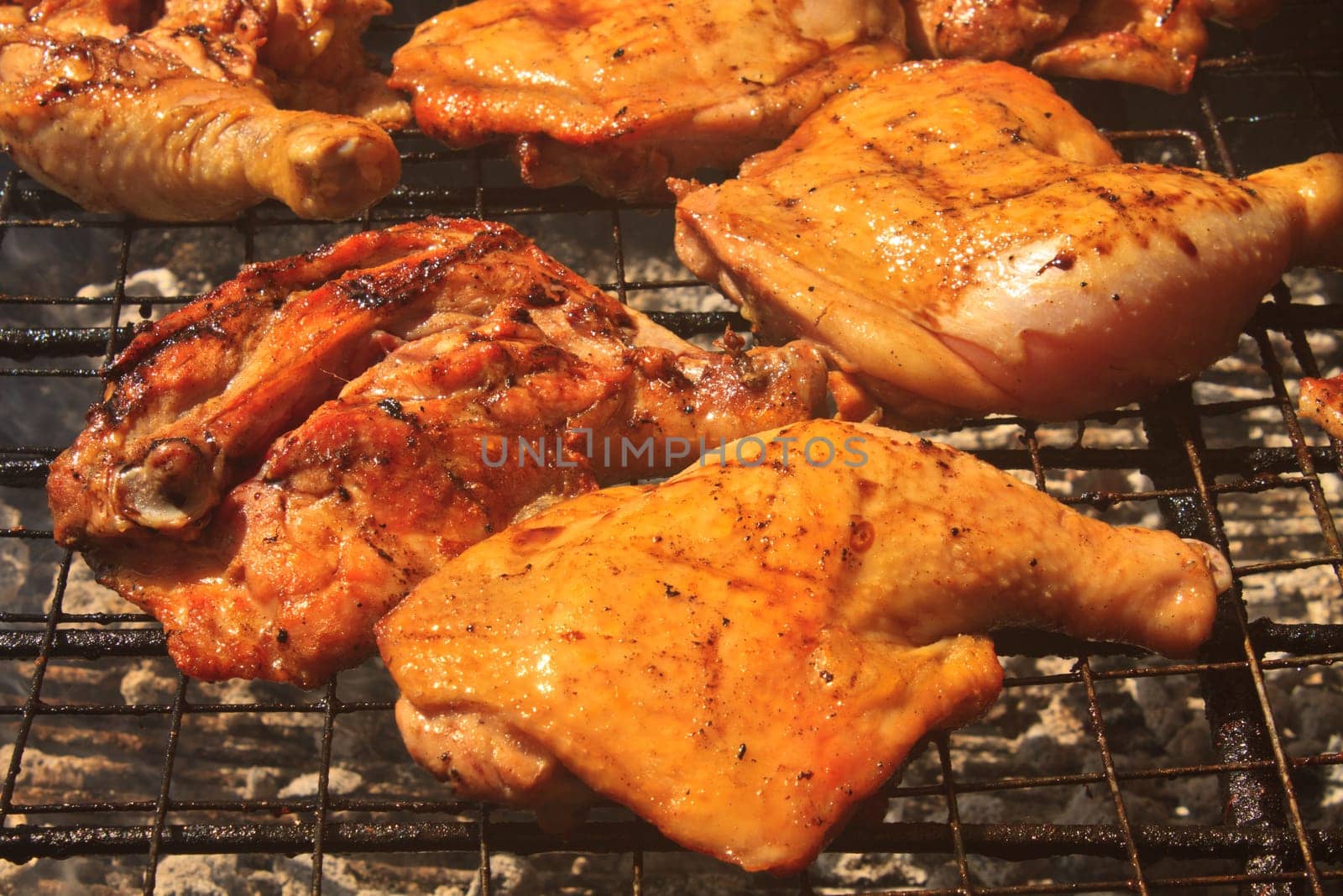 Grilled chicken thigh on the flaming grill