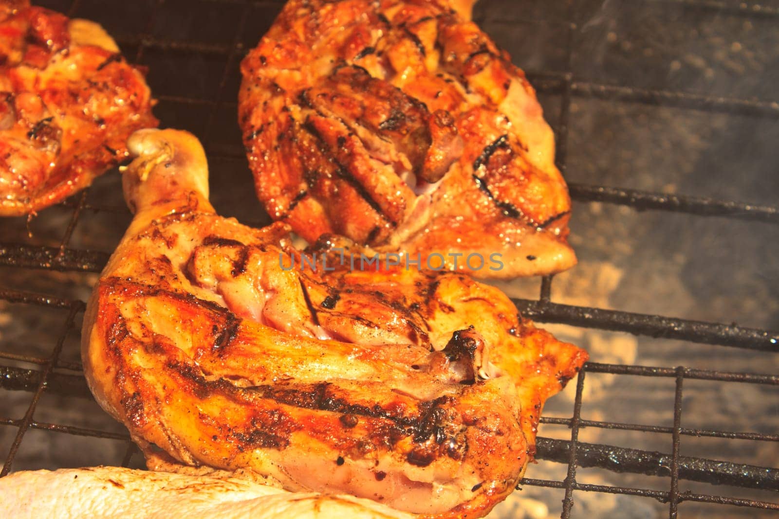 Grilled chicken thigh on the flaming grill