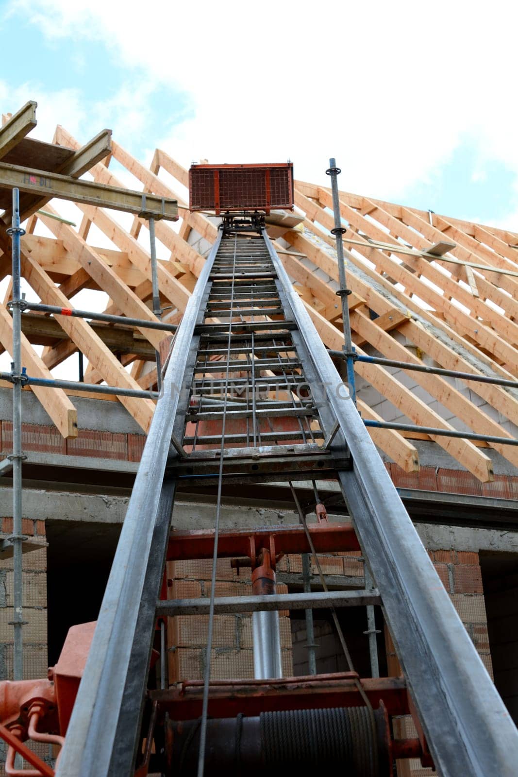 Roofing work with construction hoist