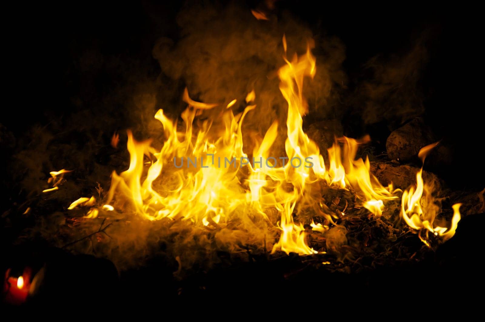 Flames and smoke fill this image of a ceremonial fire during a mayan ritual.