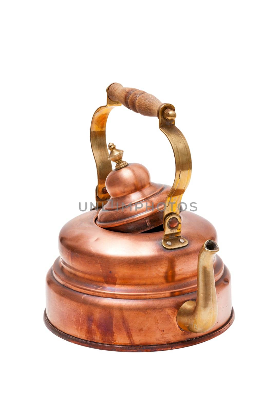 Antique tea kettle made of copper insulated against a white background