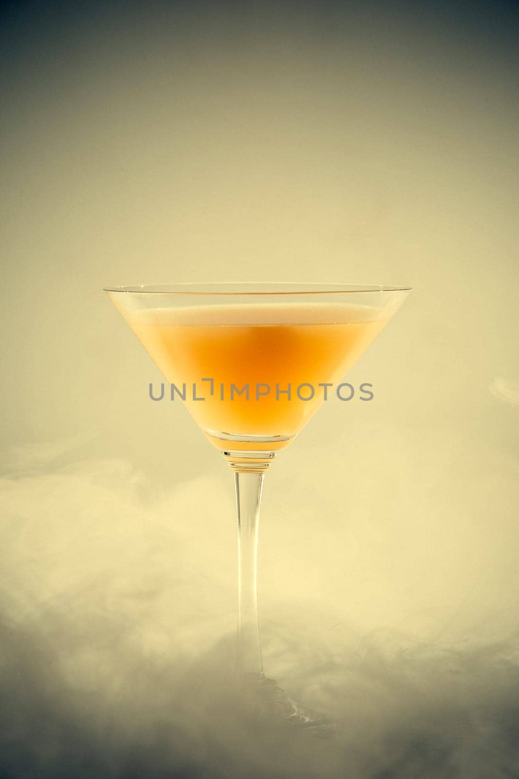A classical drink  glass with fruit juice