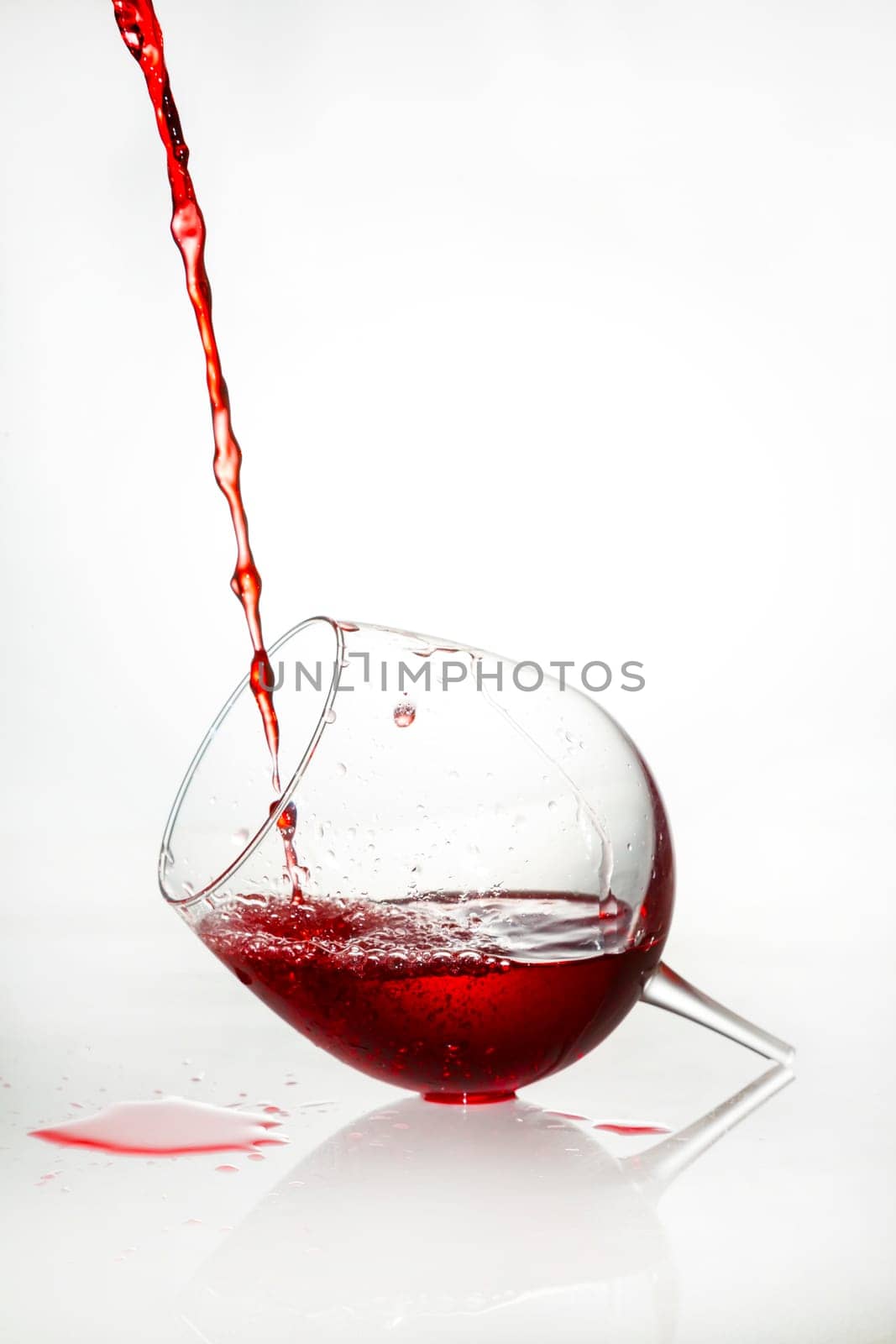 A broken glass filled with red liquid