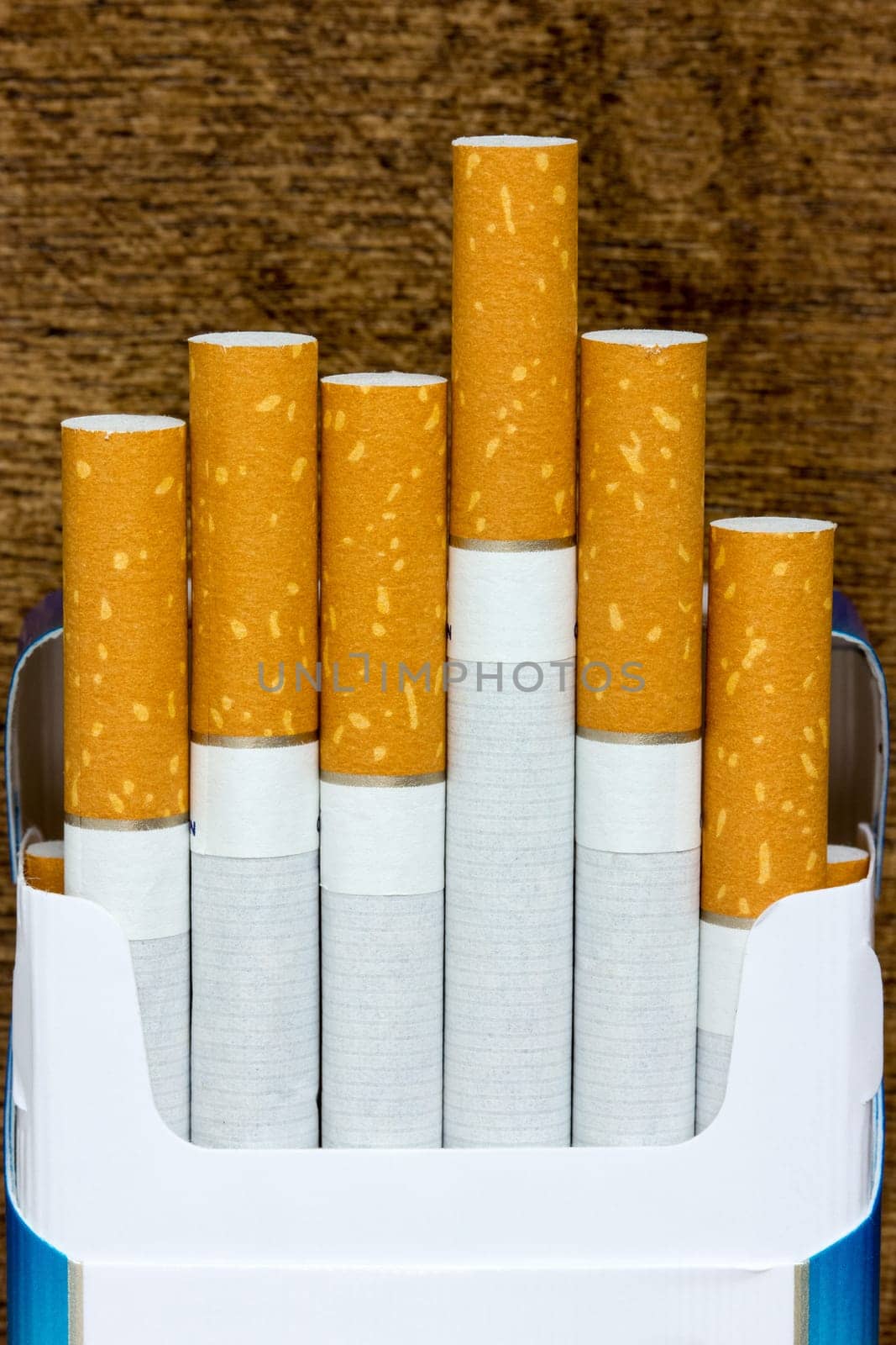 Open pack of cigarettes on the wooden table