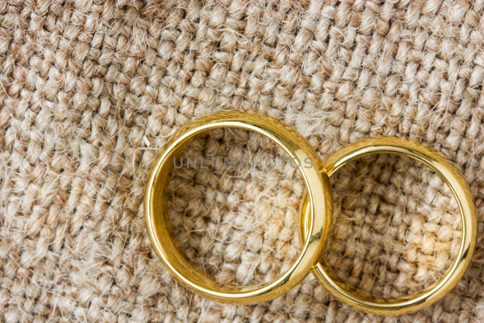 Two golden wedding rings on the burlap