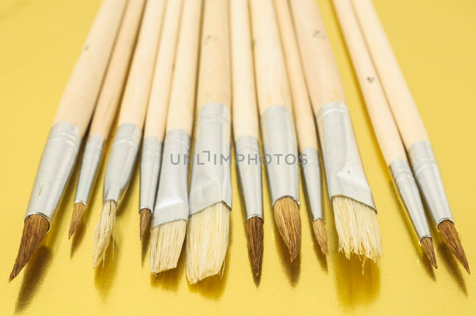 New Wooden Different Paintbrush Set Texture over a Colored Background