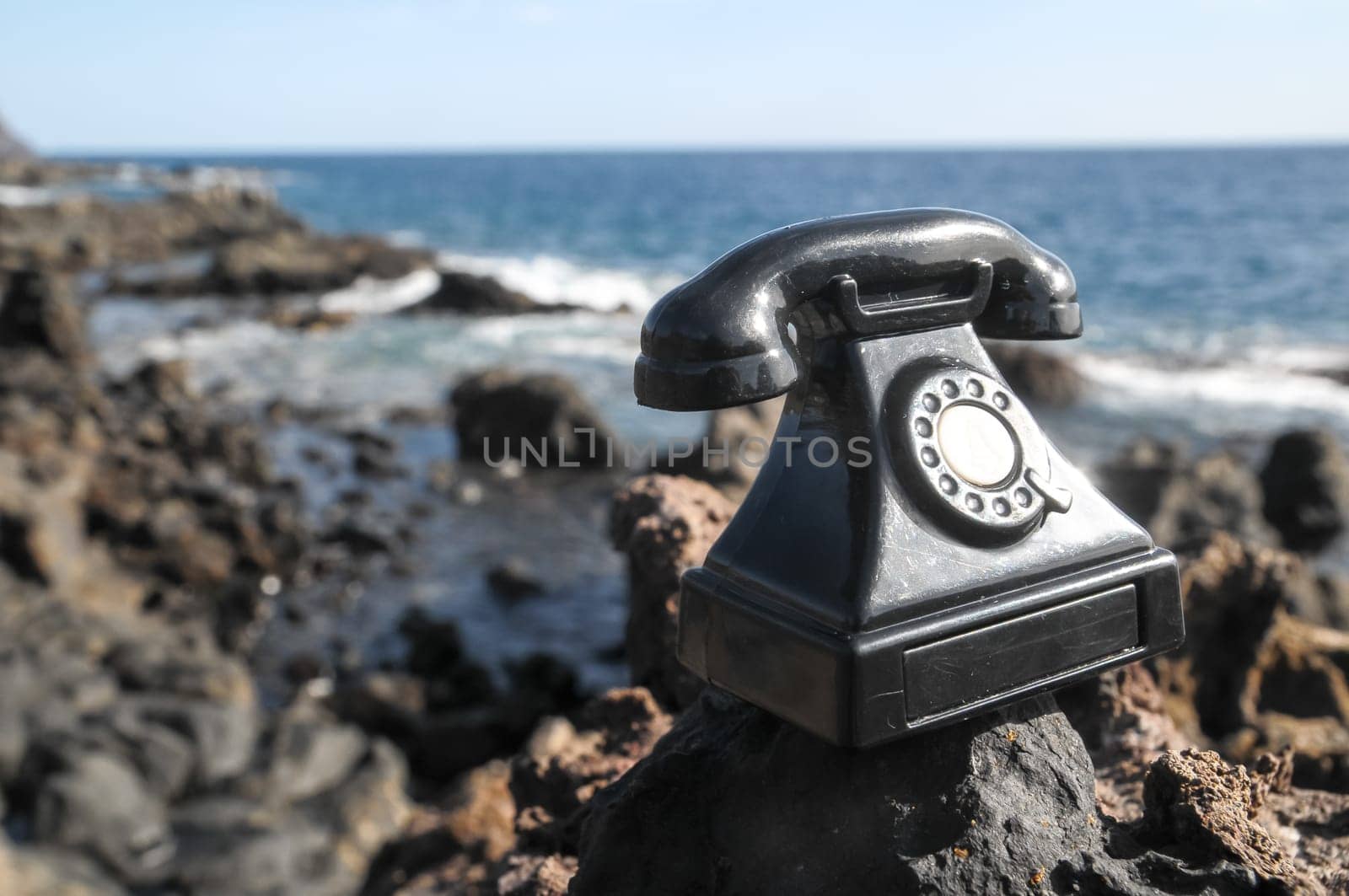 International Communications Vintage Telephone Toy on the Volcanic Rocks