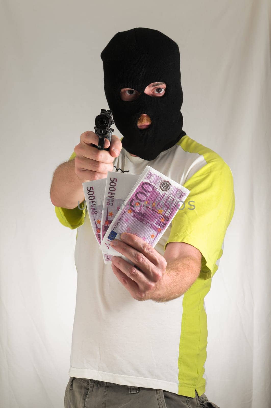 White Dressed Young Man Holding a Pistol Gun