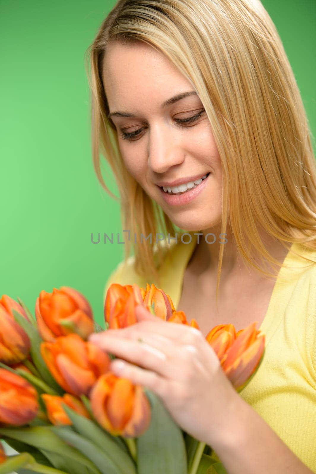 Woman looking down spring flowers orange tulips looking down