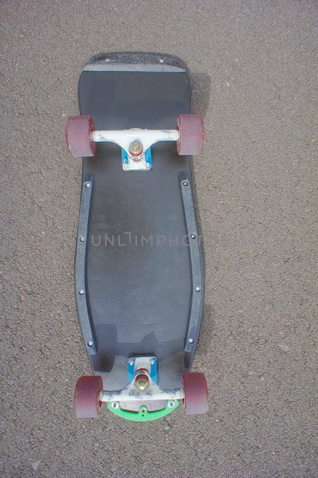 Vintage Style Longboard Black Skateboard on an Empty Asphalt Desert Road