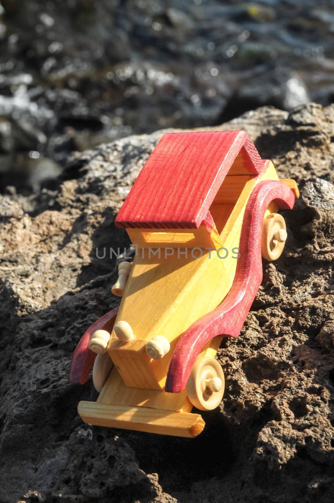Transportation Concept Wooden Toy Car on the Rocks