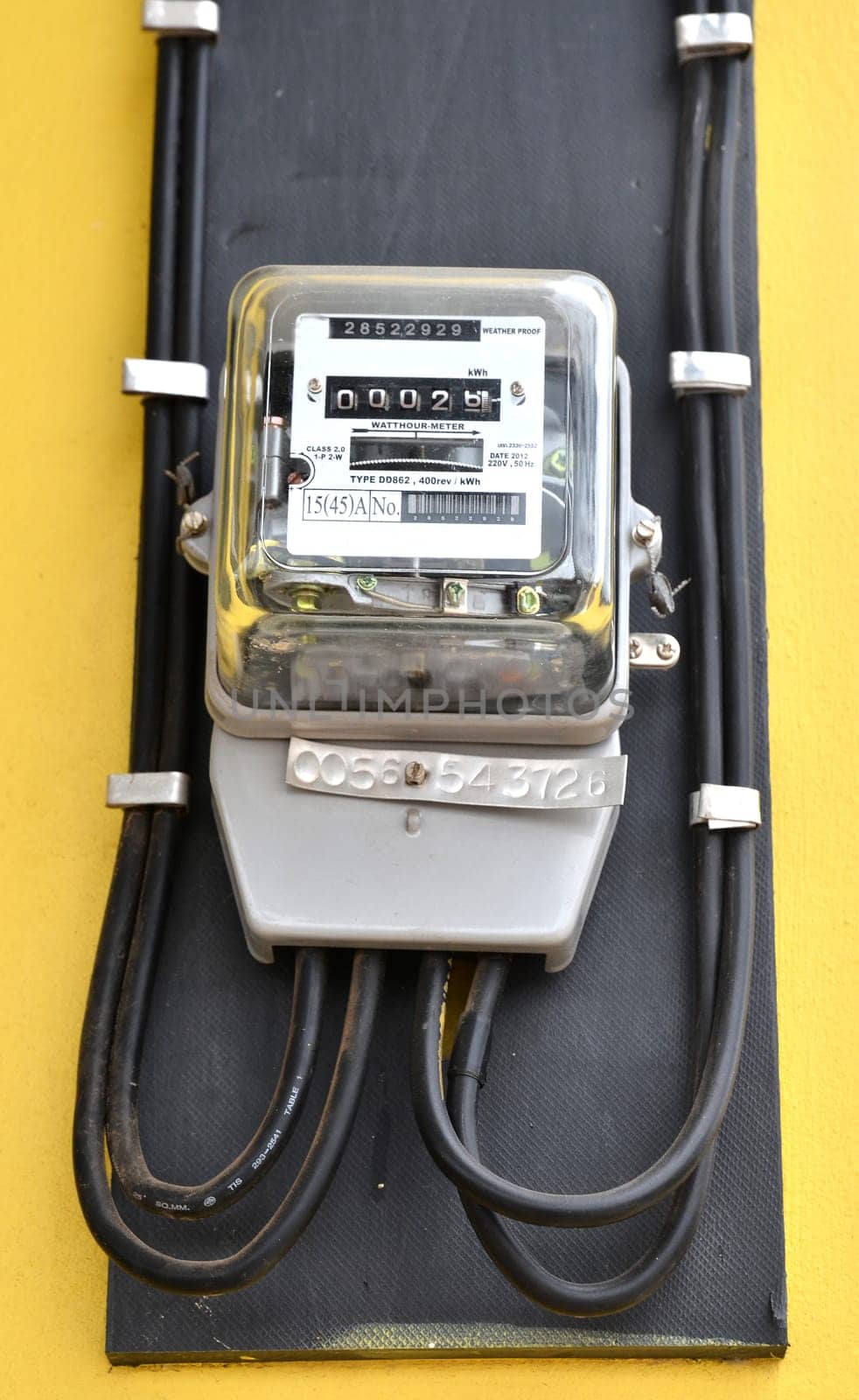watthour meter on yellow wall