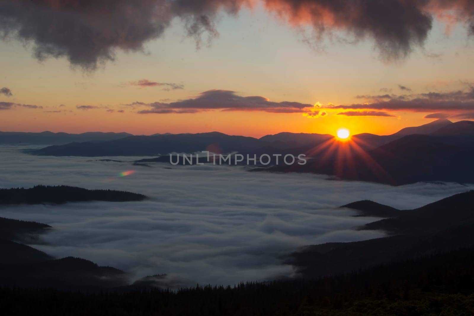 Sunrise in the mountains above the clouds