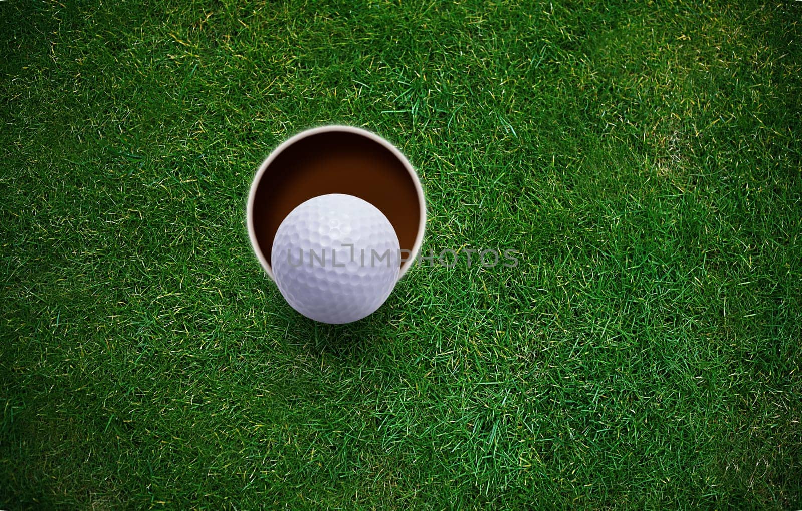 golf ball on lip of hole .