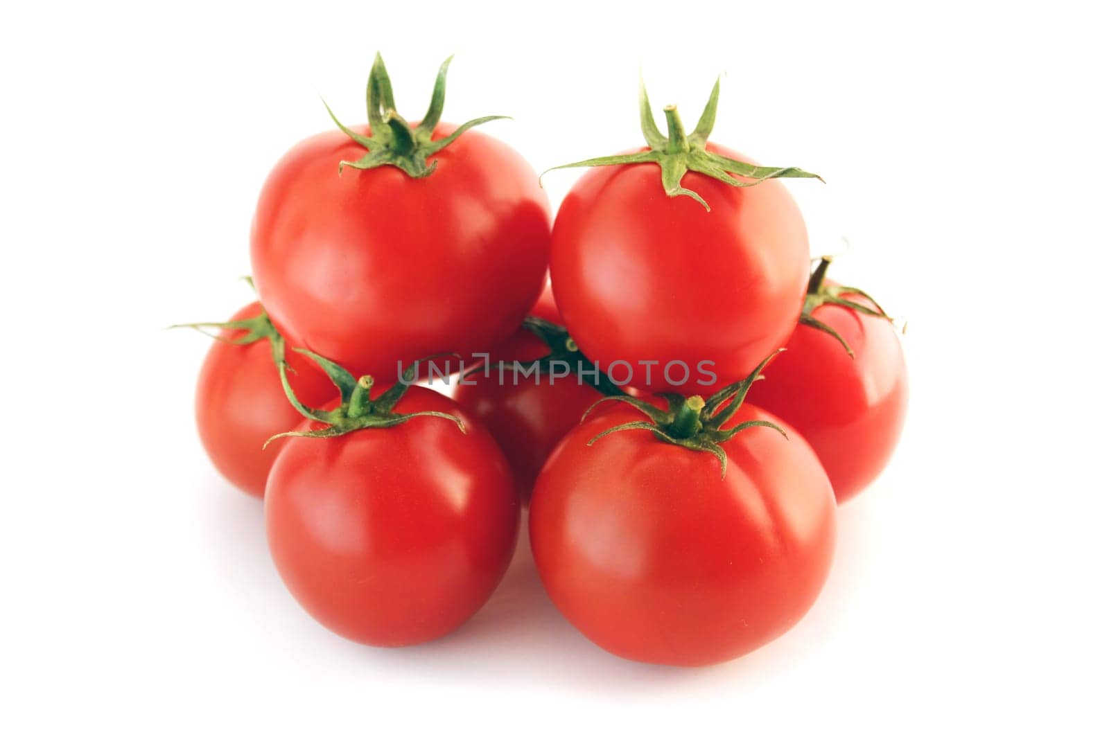 Fresh red tomato with green stem on white background