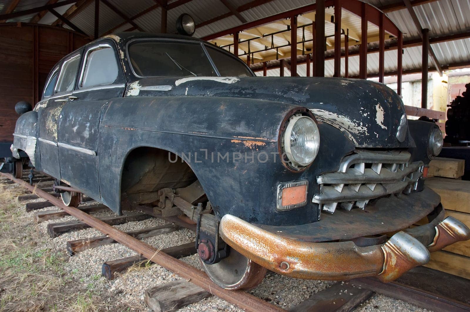Old rusty car with trane weels. Made for traveling by railways