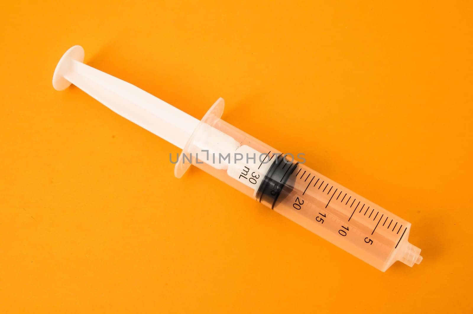 Big Black and White Syringe on a Colored Background