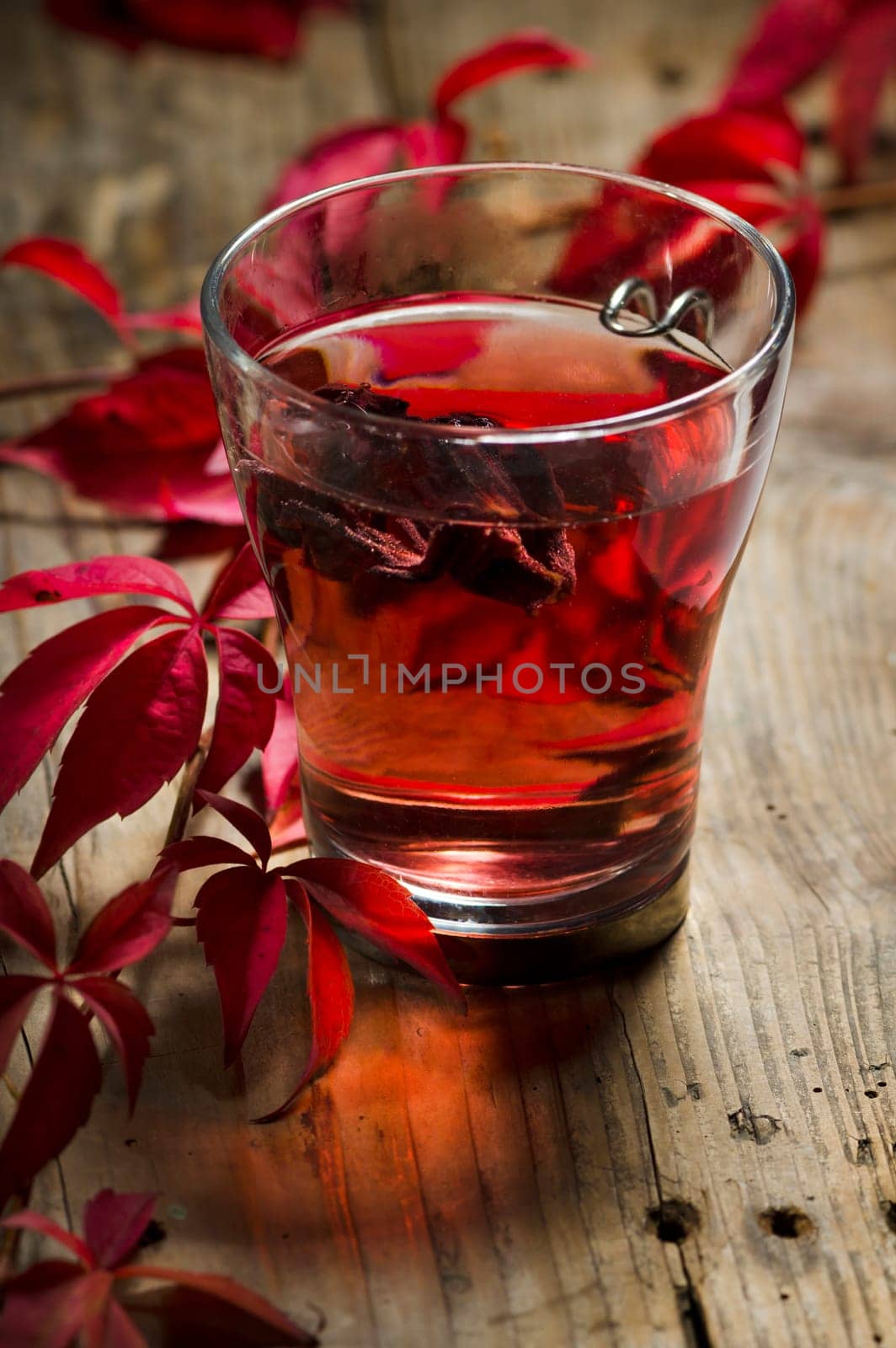 Autumn concept. Cup of tea with autumn leaves on rustic table.