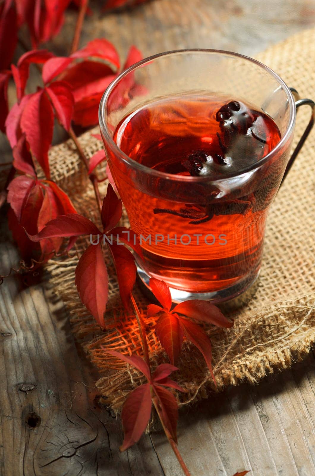 Autumn concept. Cup of tea with autumn leaves on rustic table.