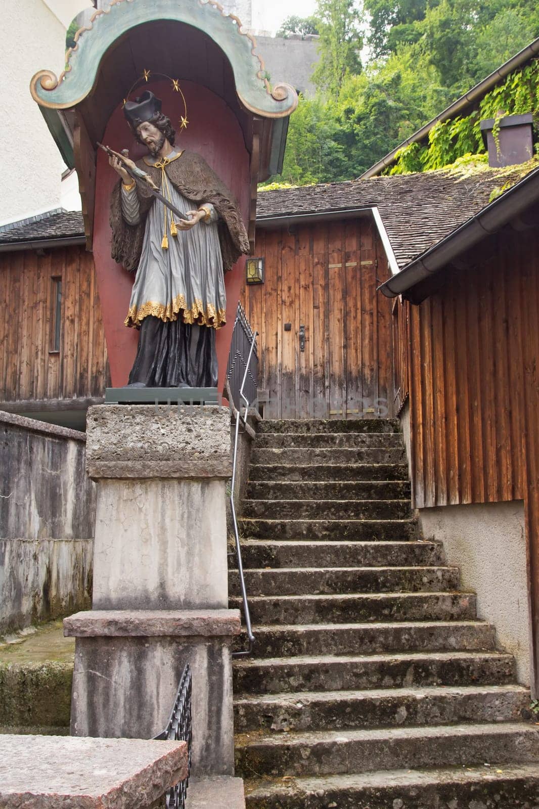 Old stairs in the historic center of Salzburg with the sacred statue (Austria)