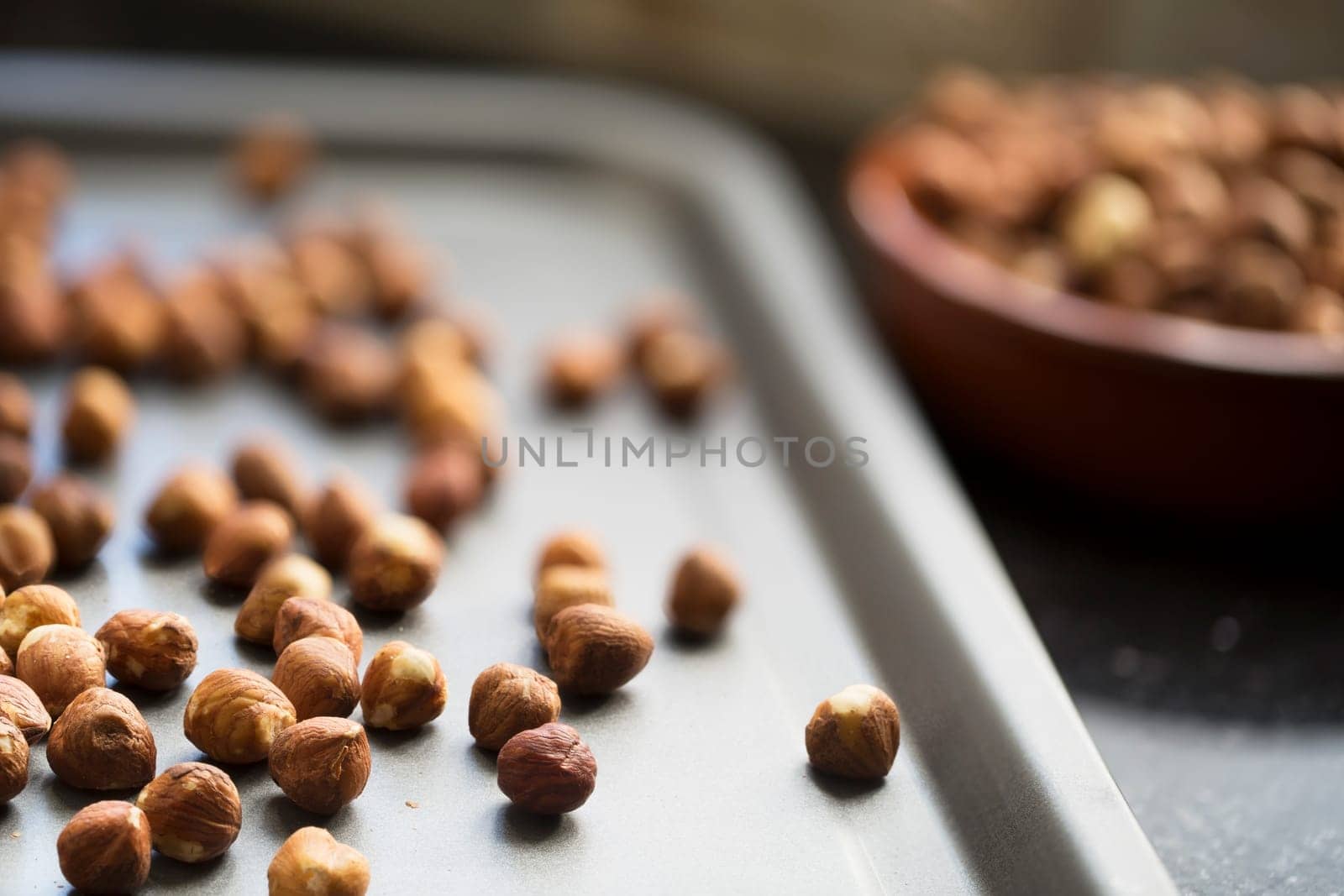 Hazelnuts on baking pan ready for roasting.
