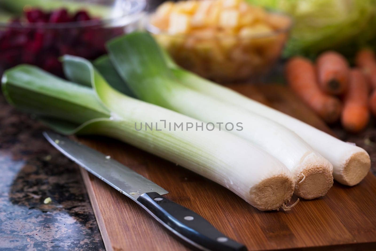 Leeks on cutting board with knife