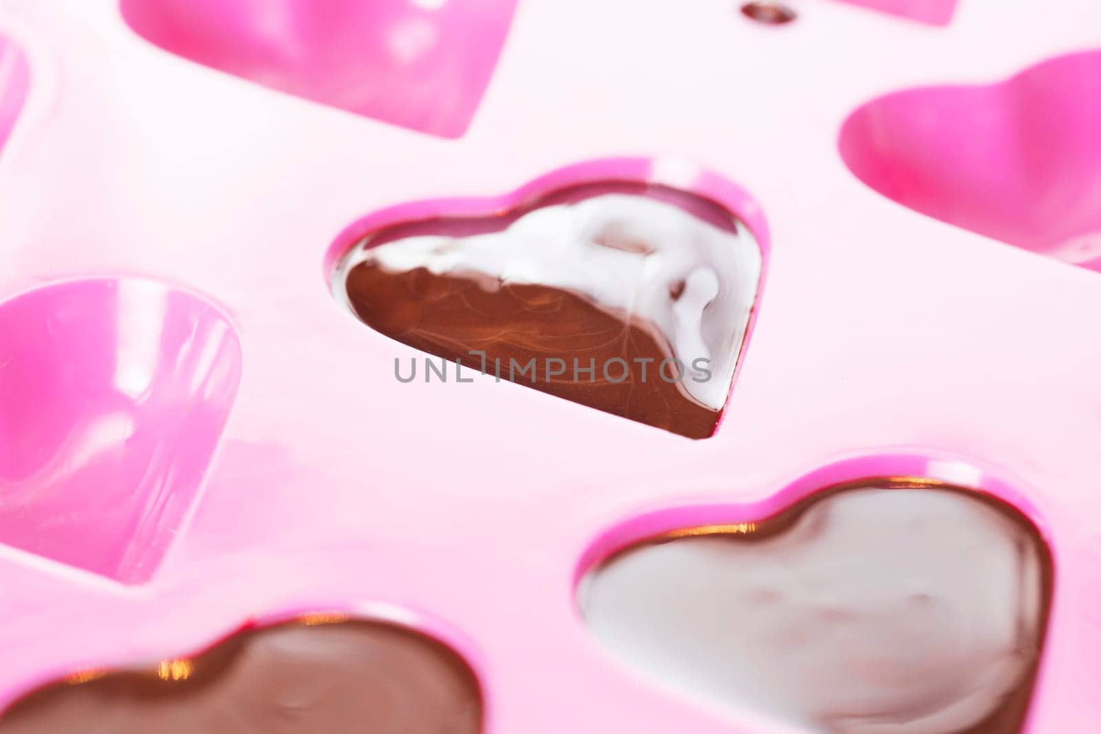 Close up of warm chocolate that has just been poured into a heart mould