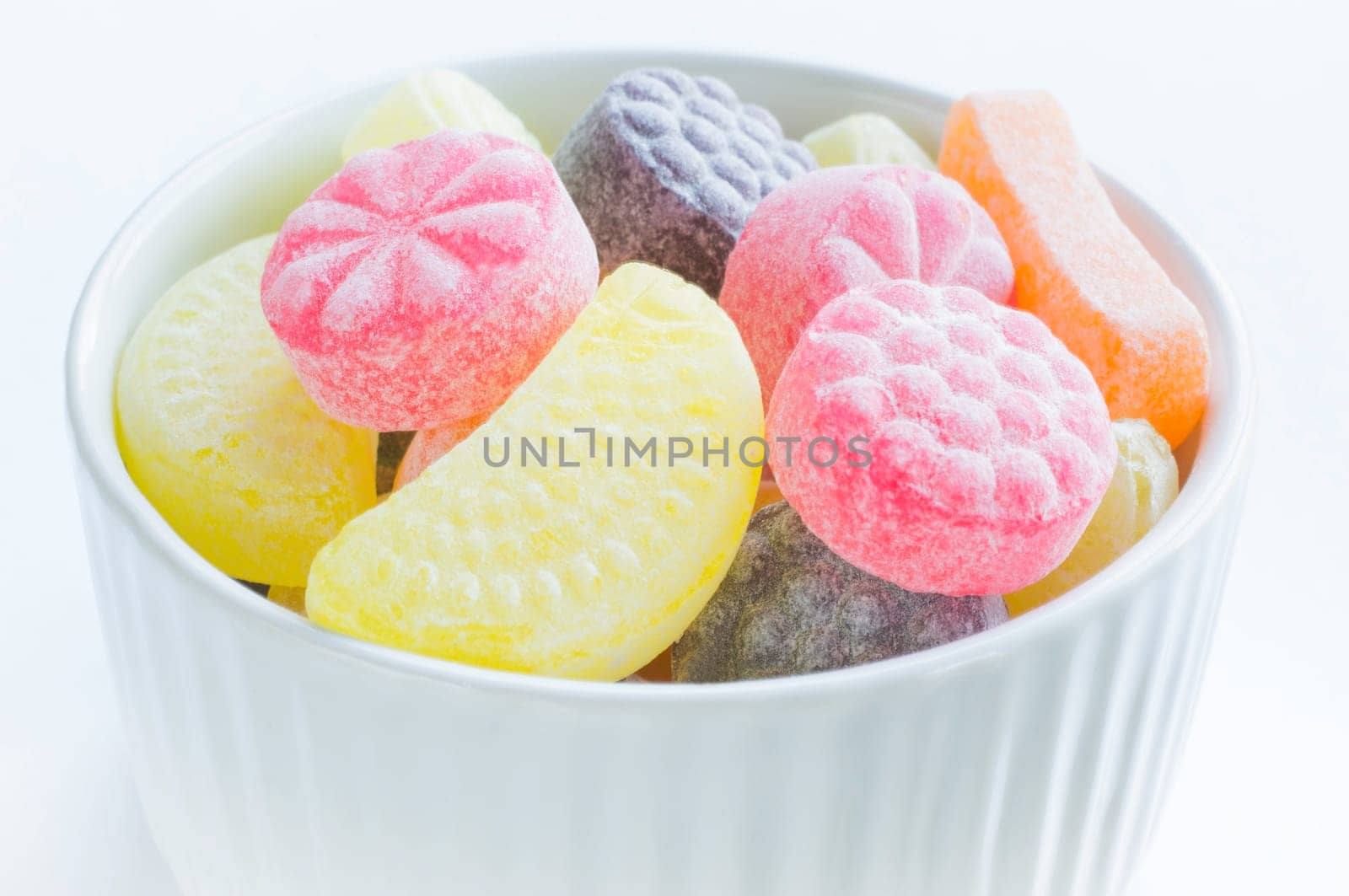 High-calorie candies in the form of fruit,in a bowl