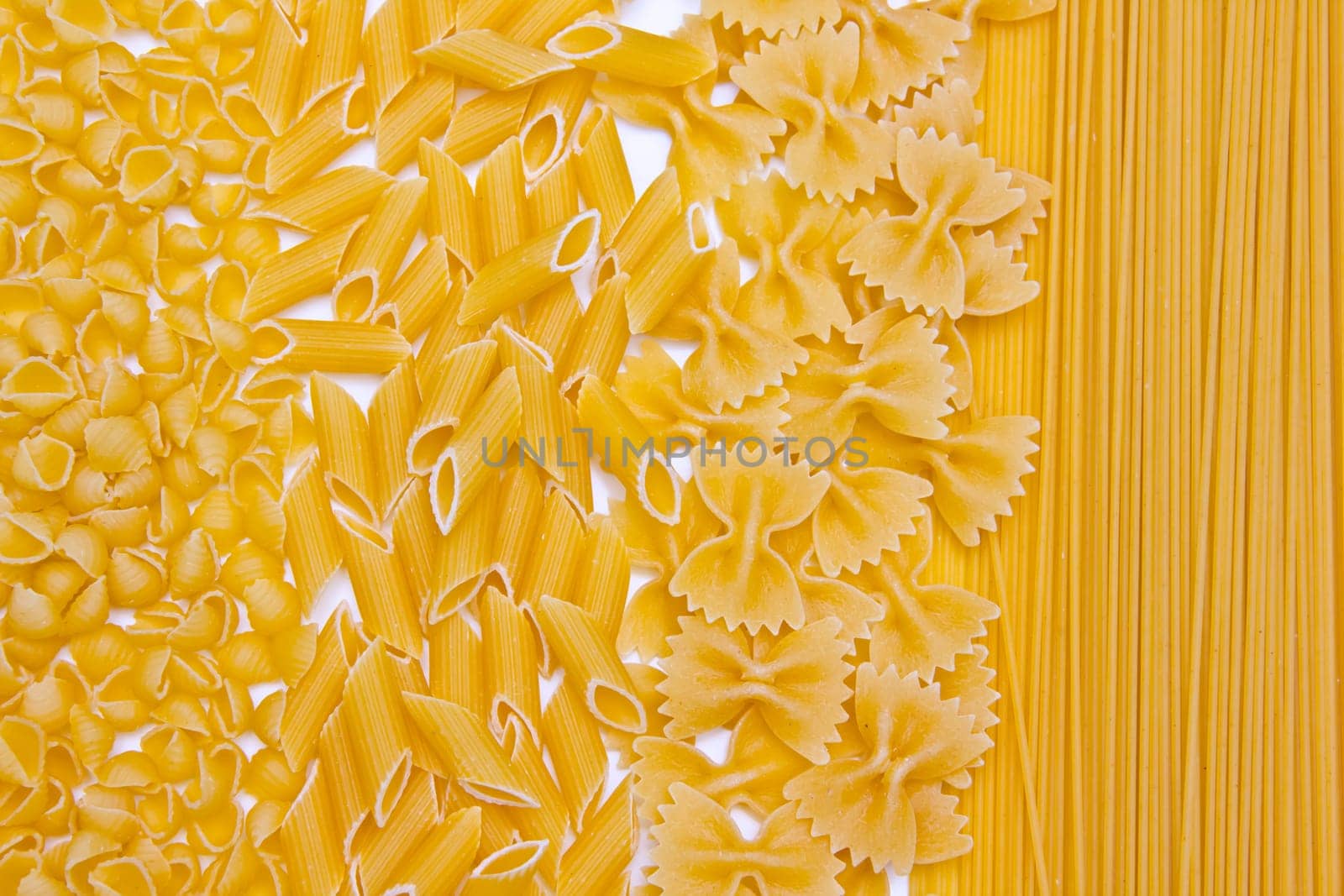 Different types of pasta on white background