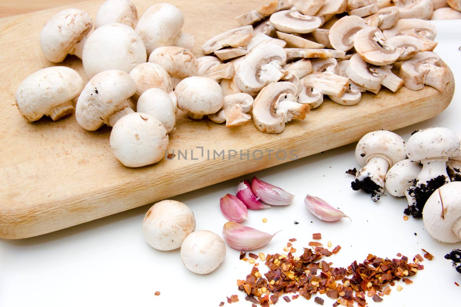 Mushrooms on cutting board on white background
