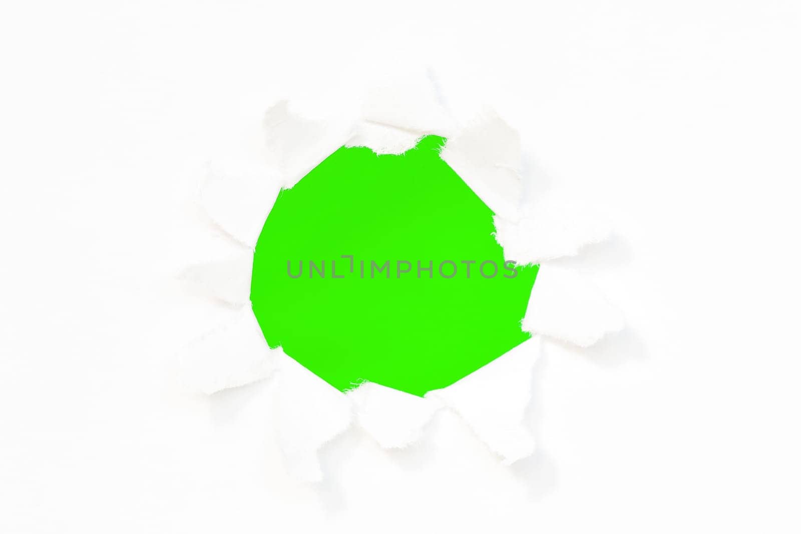 Hole in a paper with green  background inside