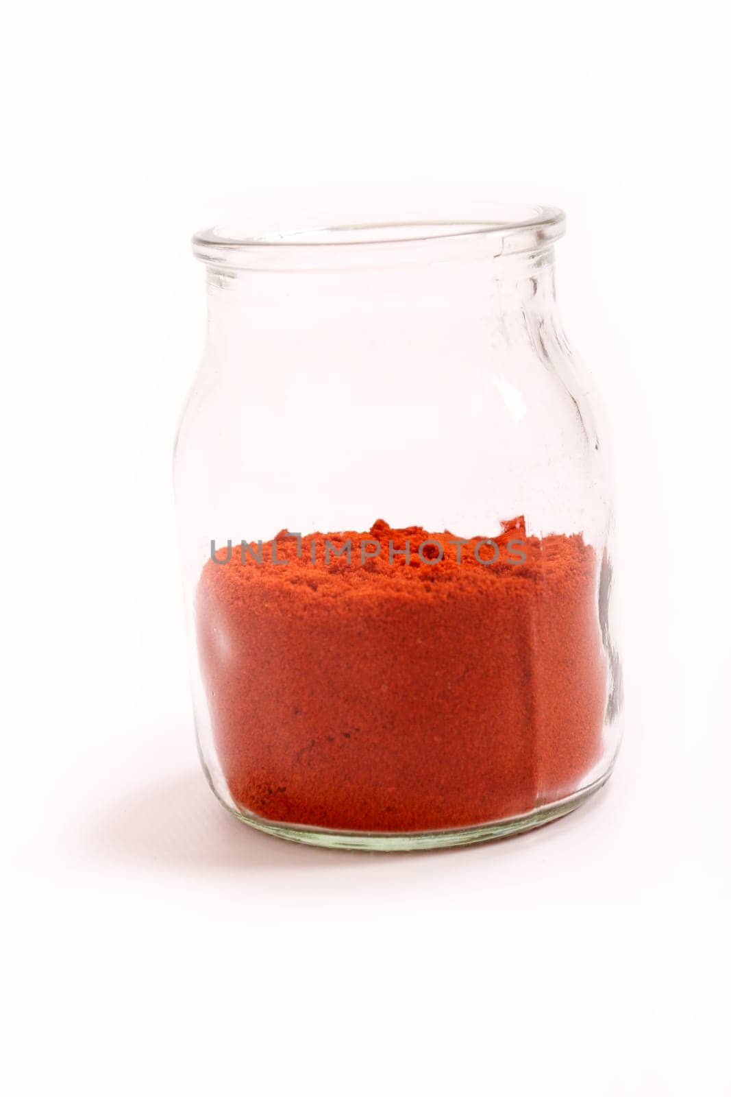 Paprika powder in a glass pot.