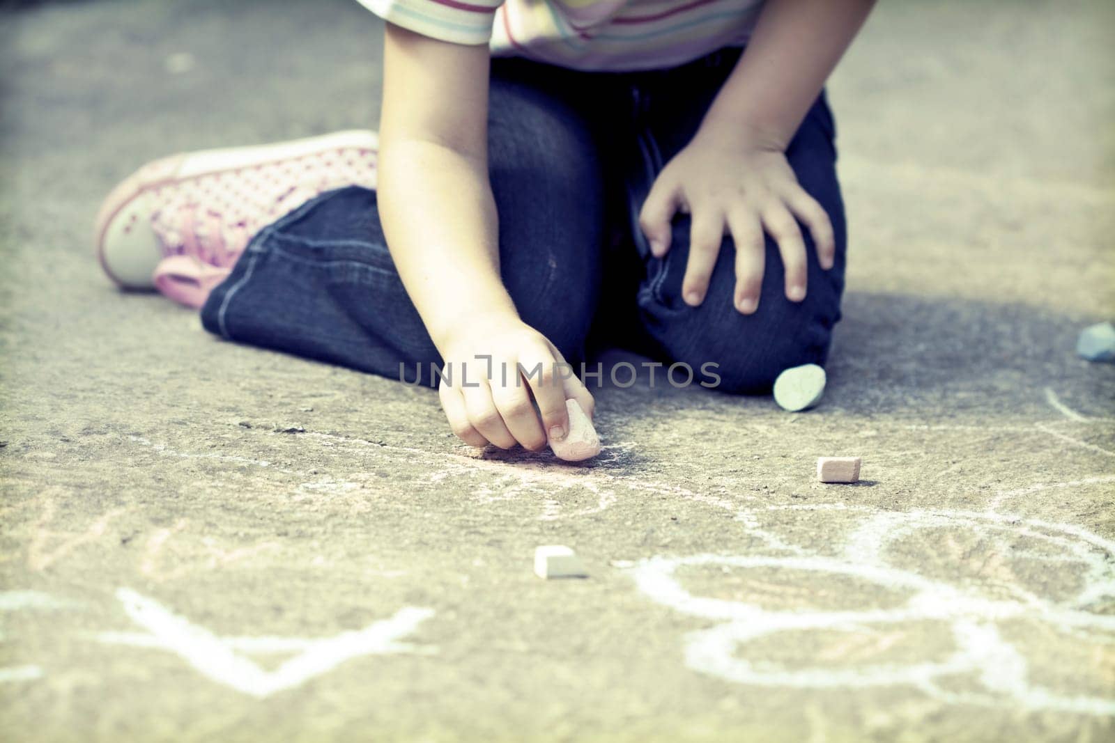 Back to school concept -Photo of girl writing with chalk on the schoolyard